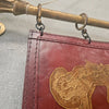 Painted Leather Wall Hanging with Two Metal Gilt Rods