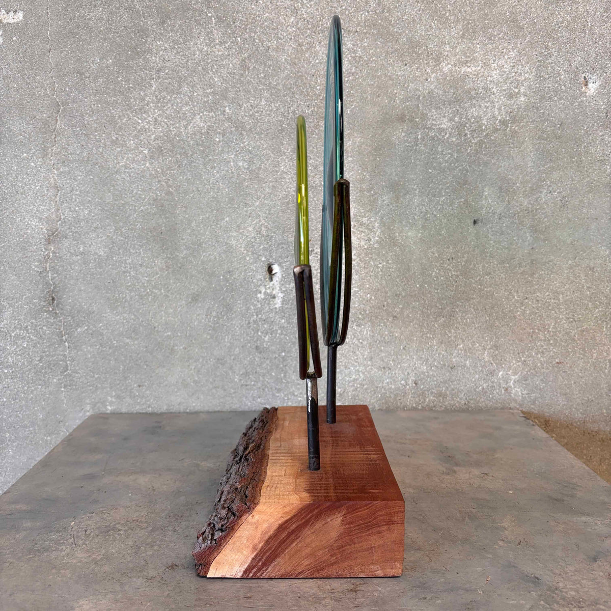 Blown Glass Disc Sculpture on Redwood